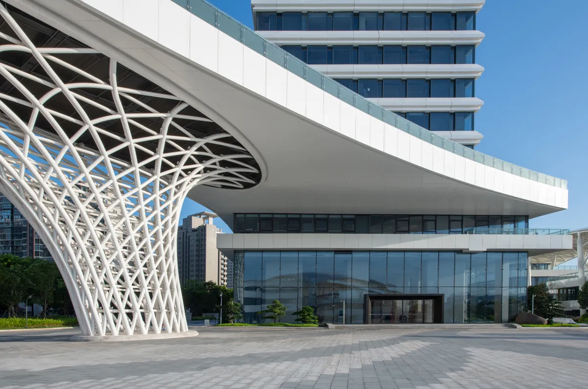Modern commercial building with parametric white facade and glass entrance