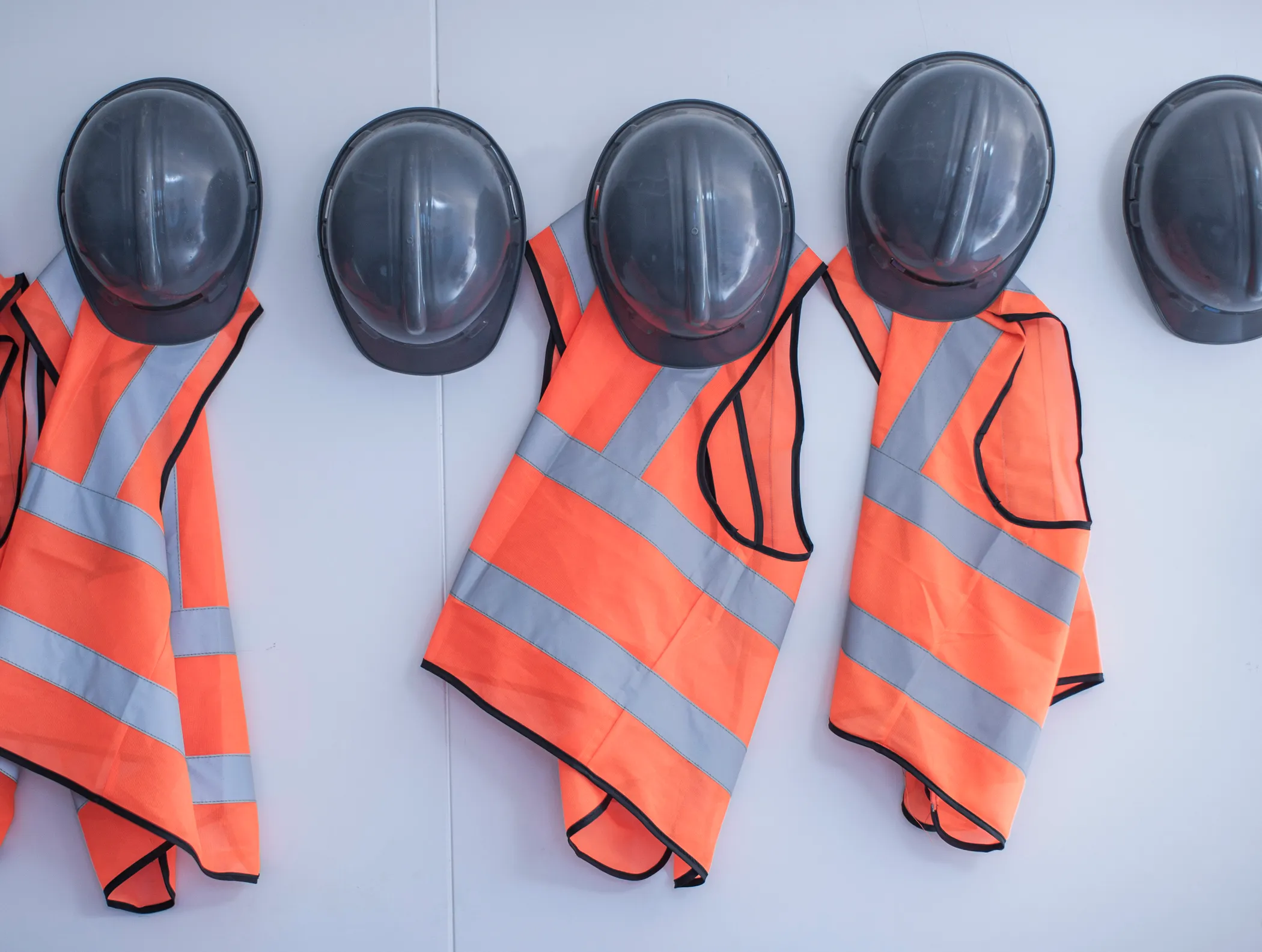 Hard hats and safety vests on a job site
