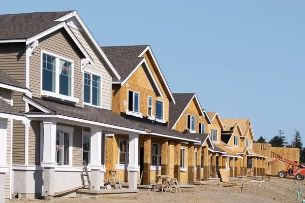 Row of framed homes under construction