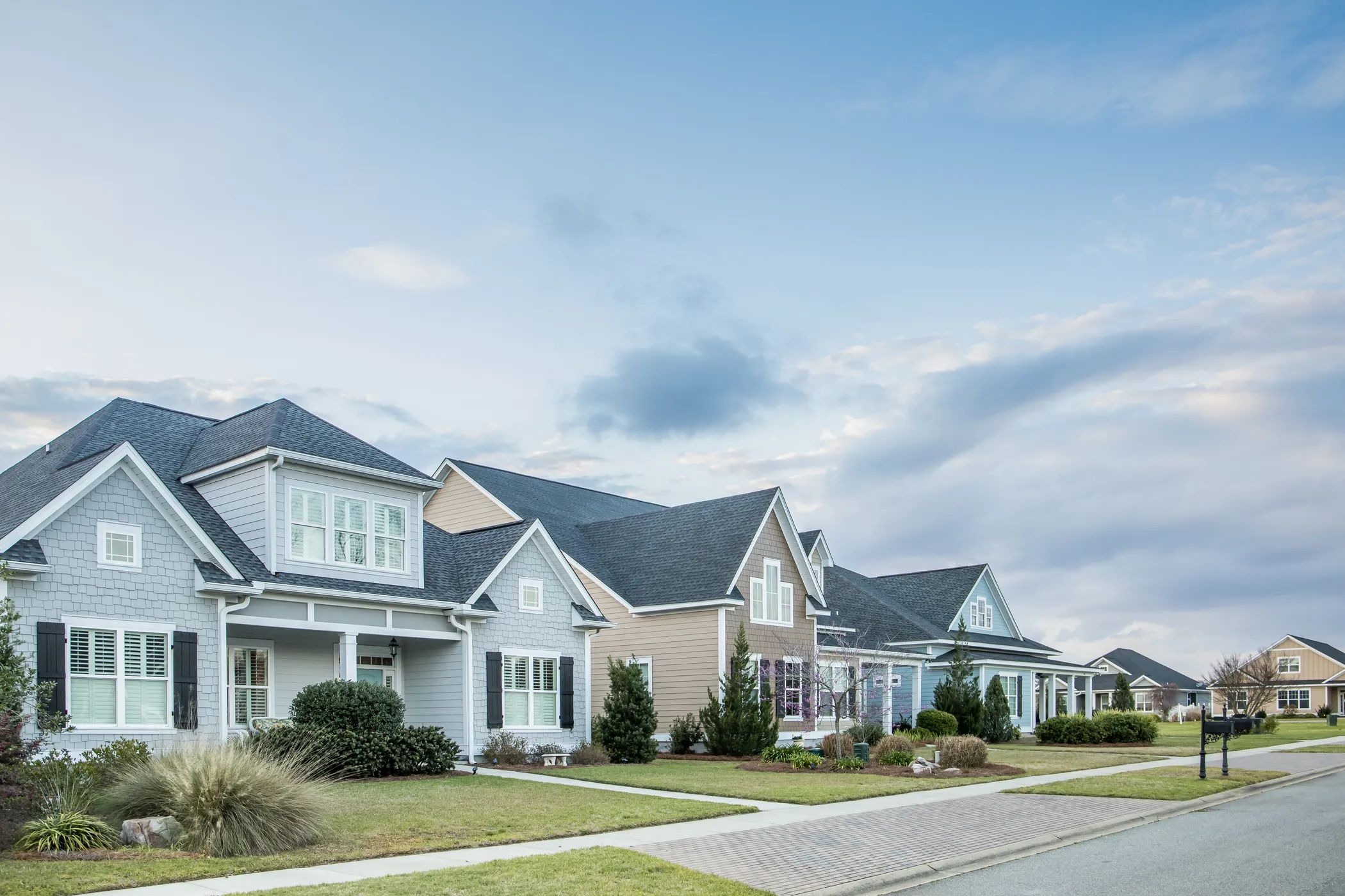 Row of completed craftsman-style homes in a residential development